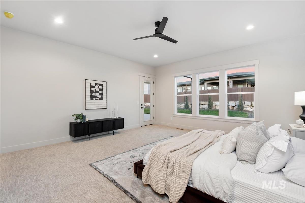 Carpeted bedroom featuring access to outside, ceiling fan, and recessed lighting