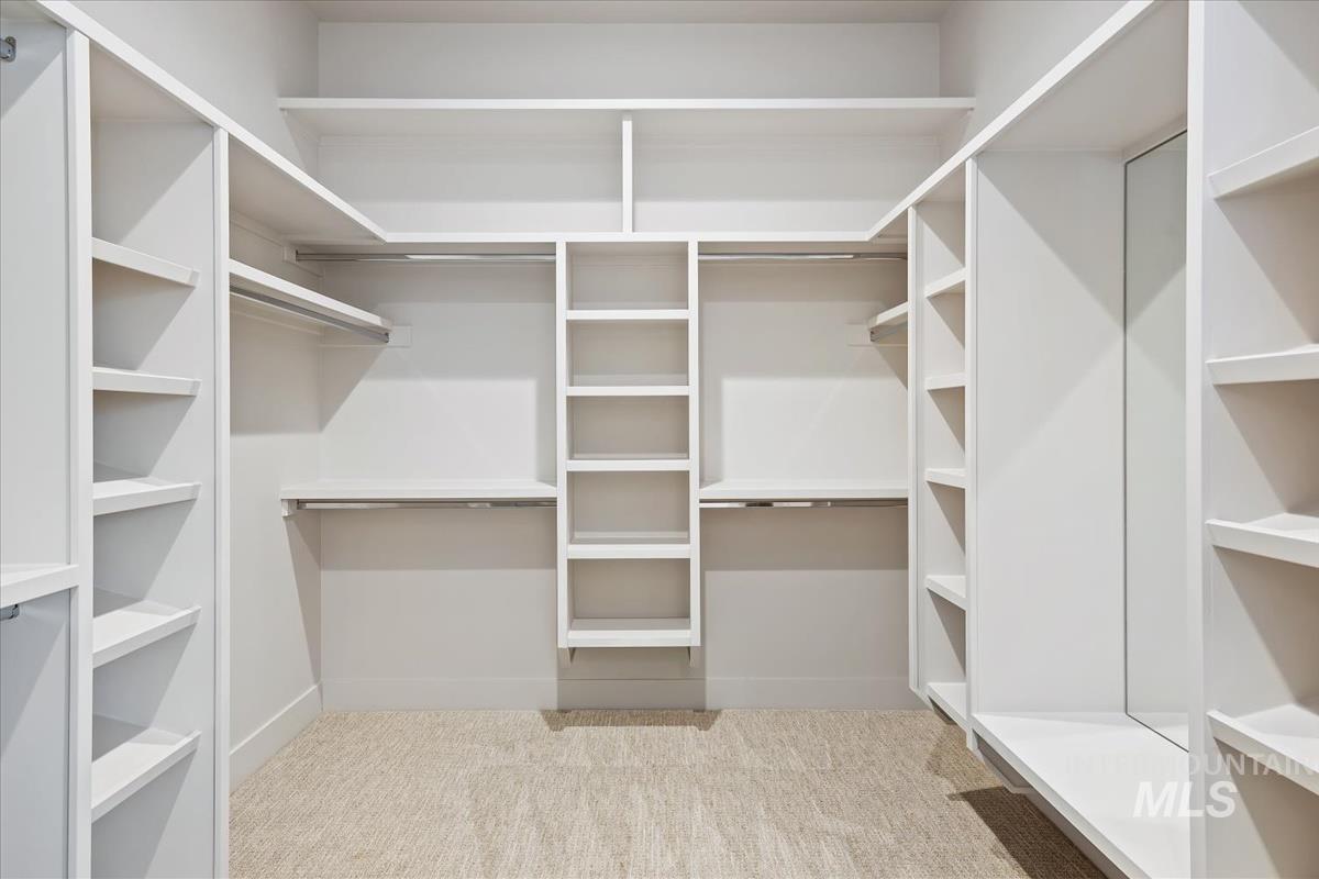 Spacious closet with light colored carpet