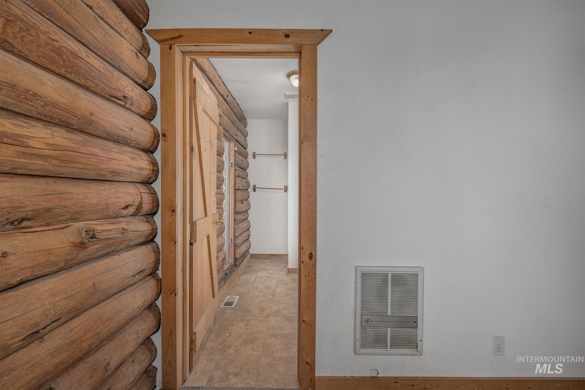 Corridor featuring rustic walls