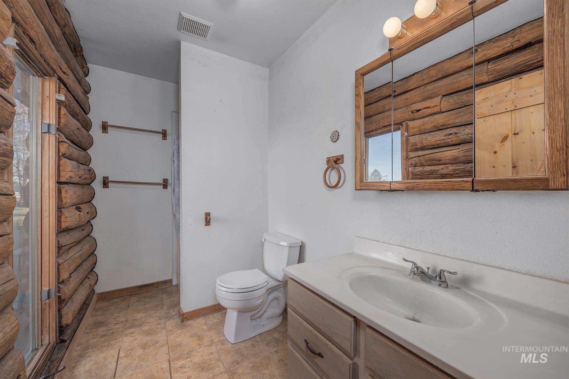Full bathroom with vanity and toilet