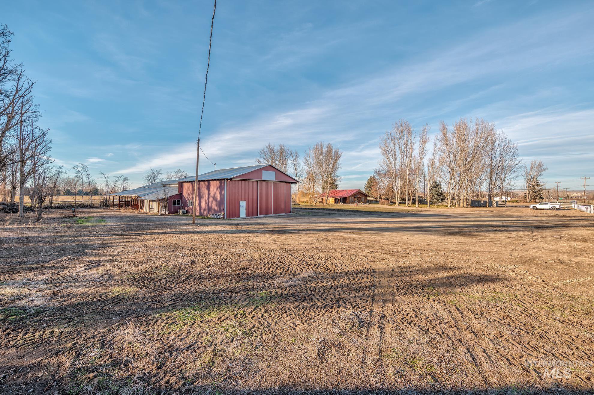 View of yard with a pole building and an outbuilding