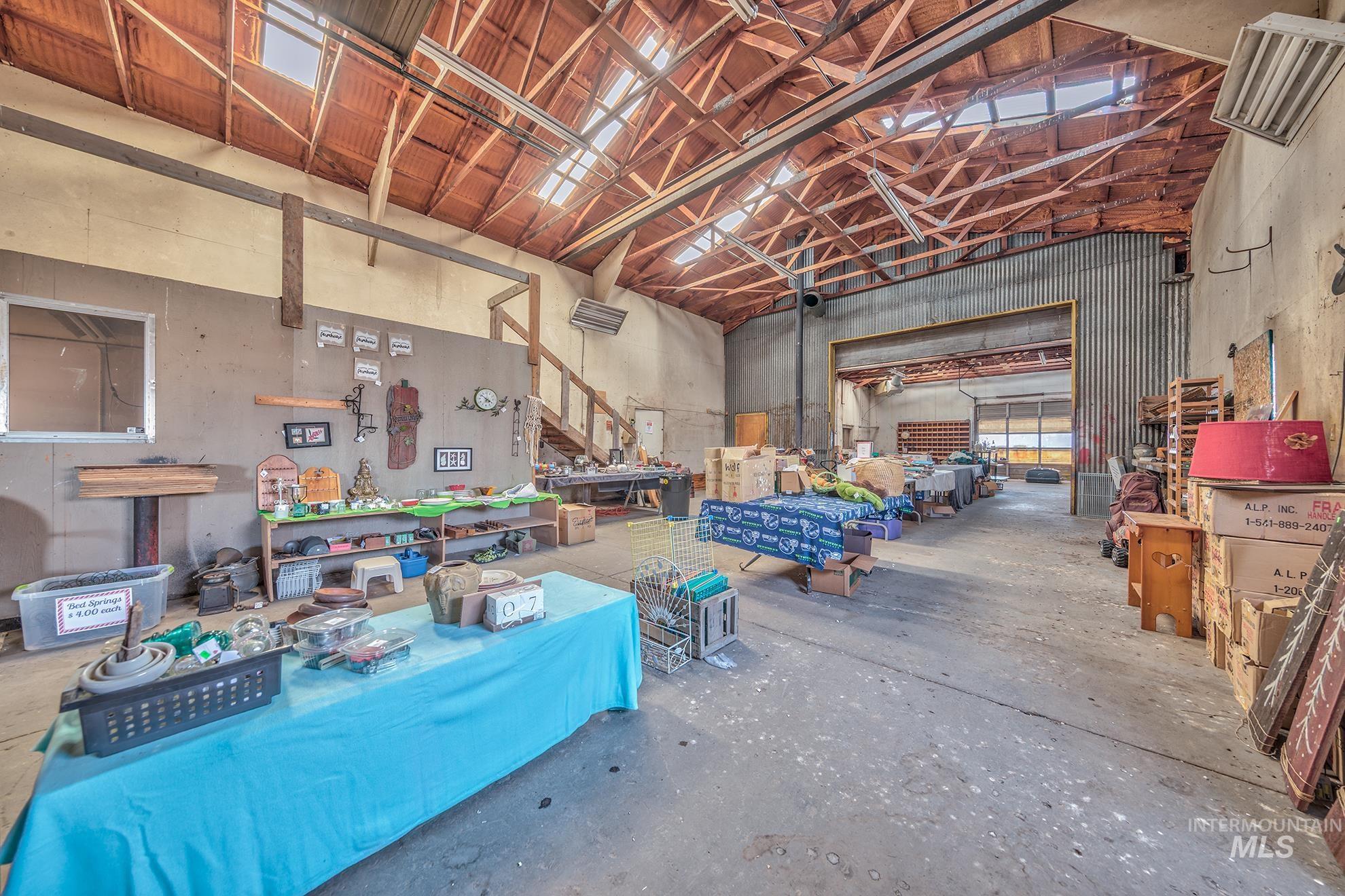 Misc room featuring high vaulted ceiling and a workshop area