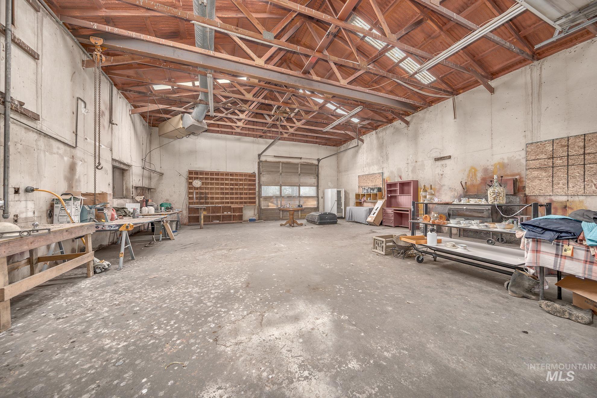 Miscellaneous room with high vaulted ceiling and a workshop area