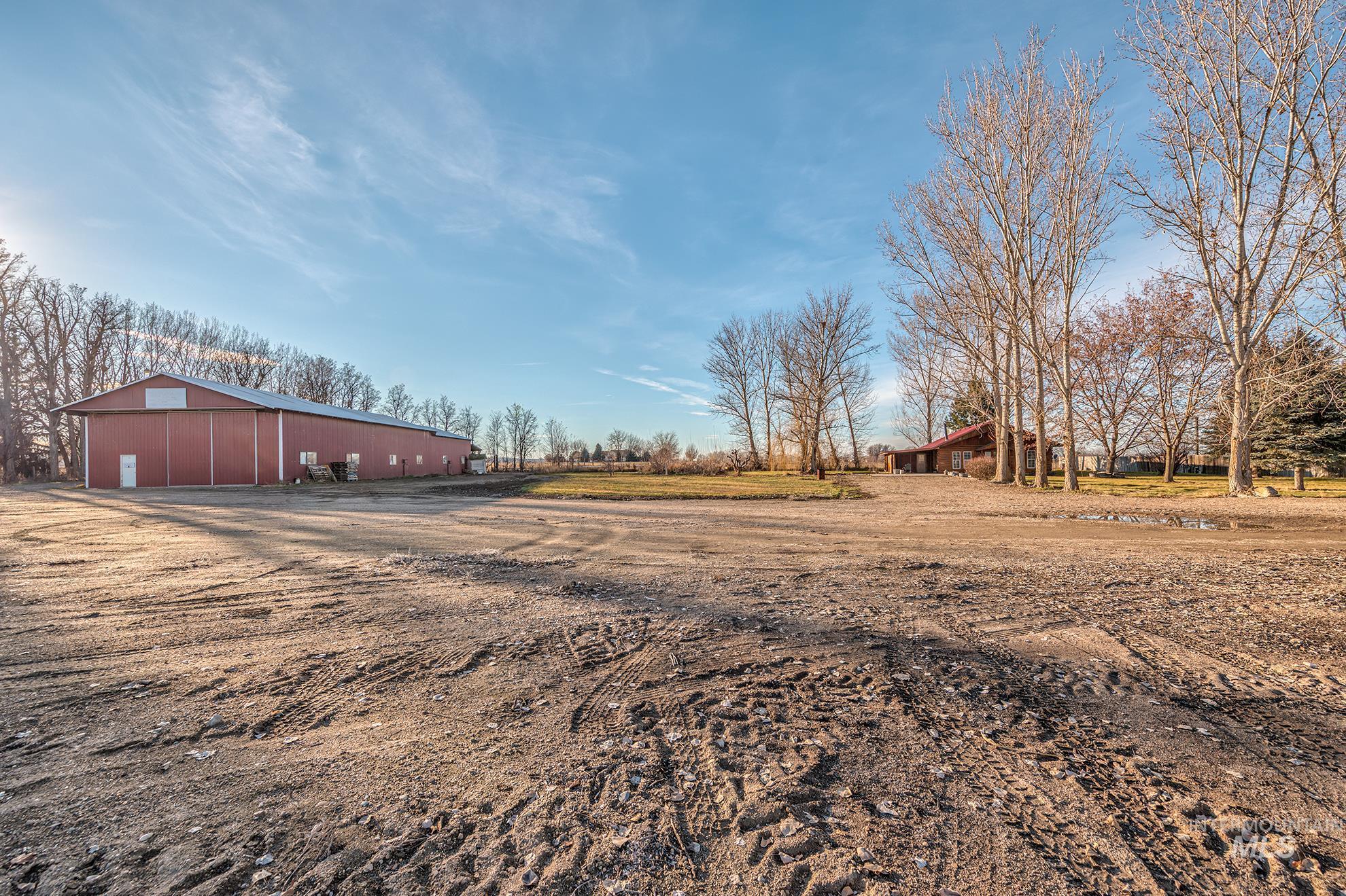 View of yard featuring a pole building and an outdoor structure