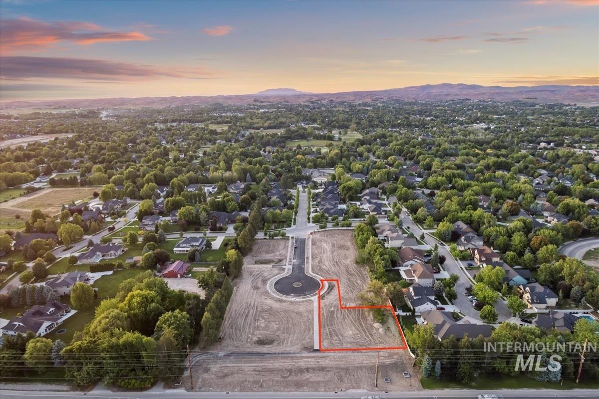 Aerial view at dusk of property boundaries highlighted, a mountain view, and a residential view