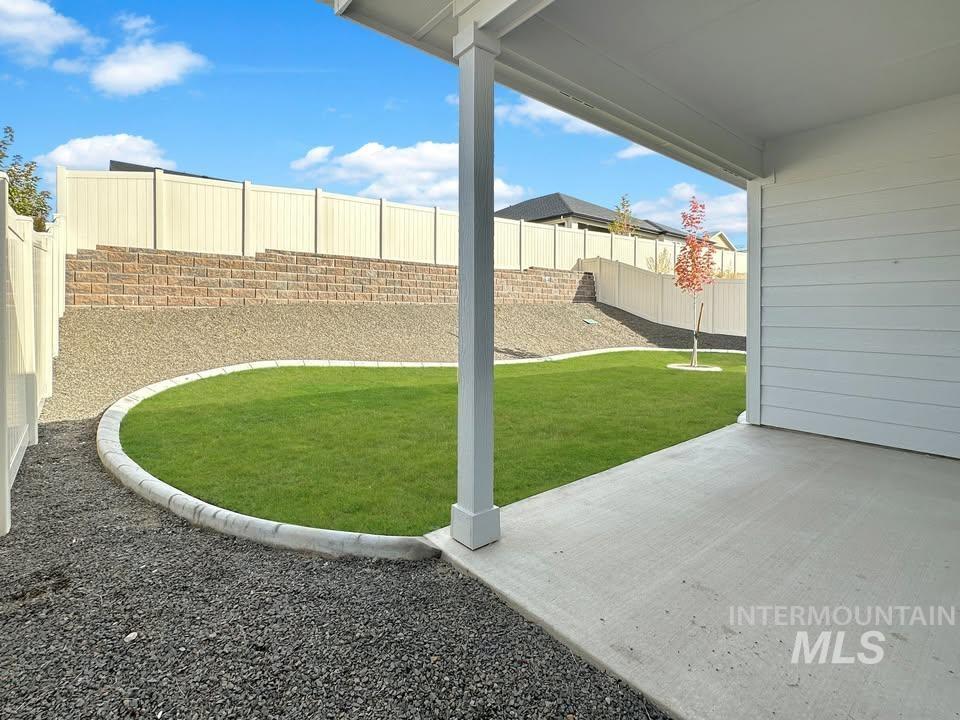 Fenced backyard with a patio