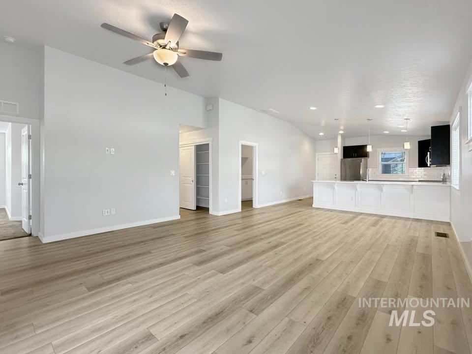 Unfurnished living room with light wood-type flooring, recessed lighting, and a ceiling fan