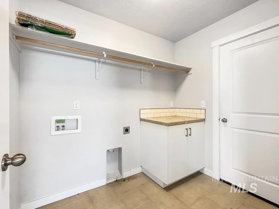 Laundry area with hookup for an electric dryer, washer hookup, and cabinet space