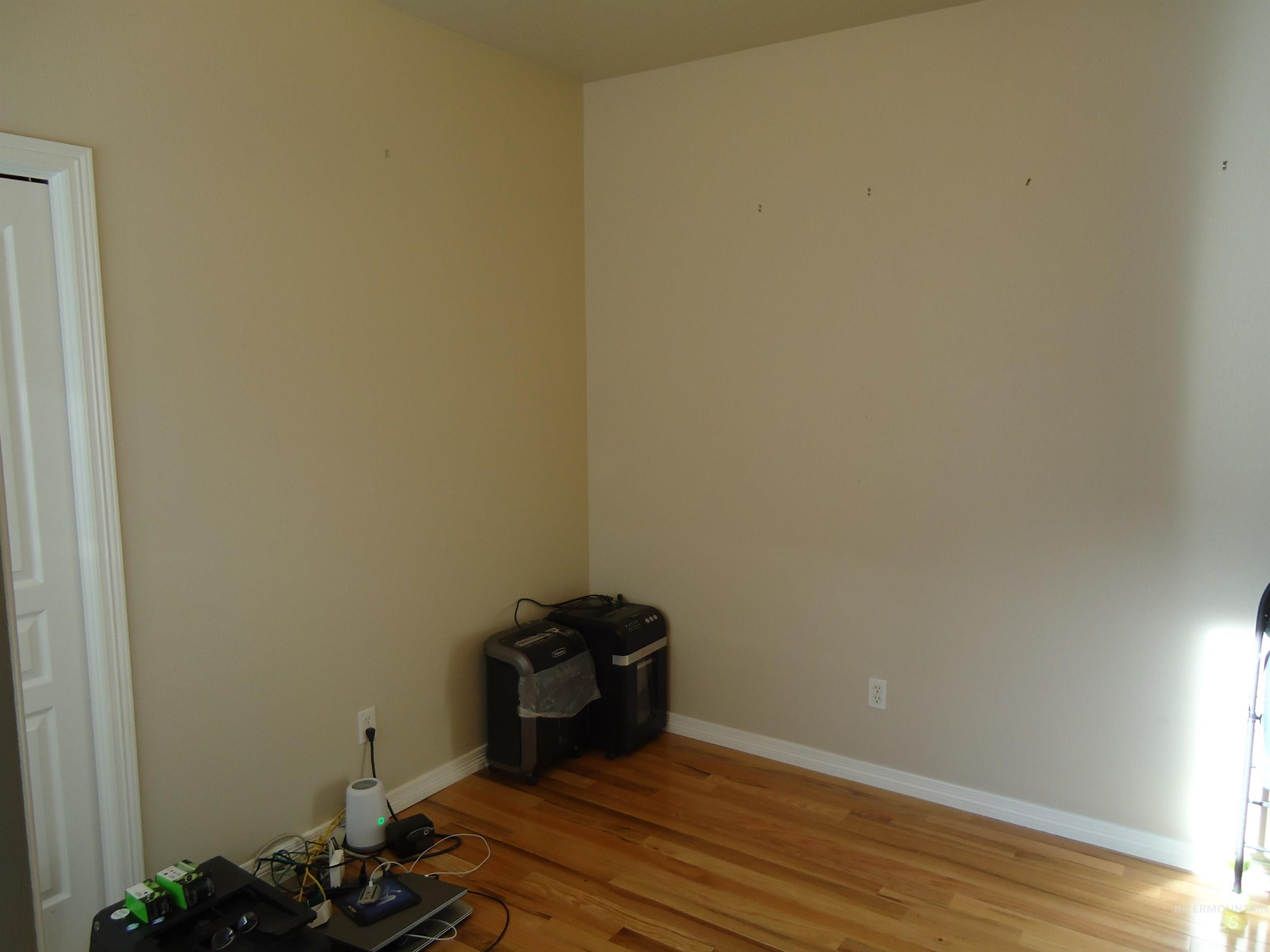 Unfurnished room featuring light wood-style flooring and baseboards