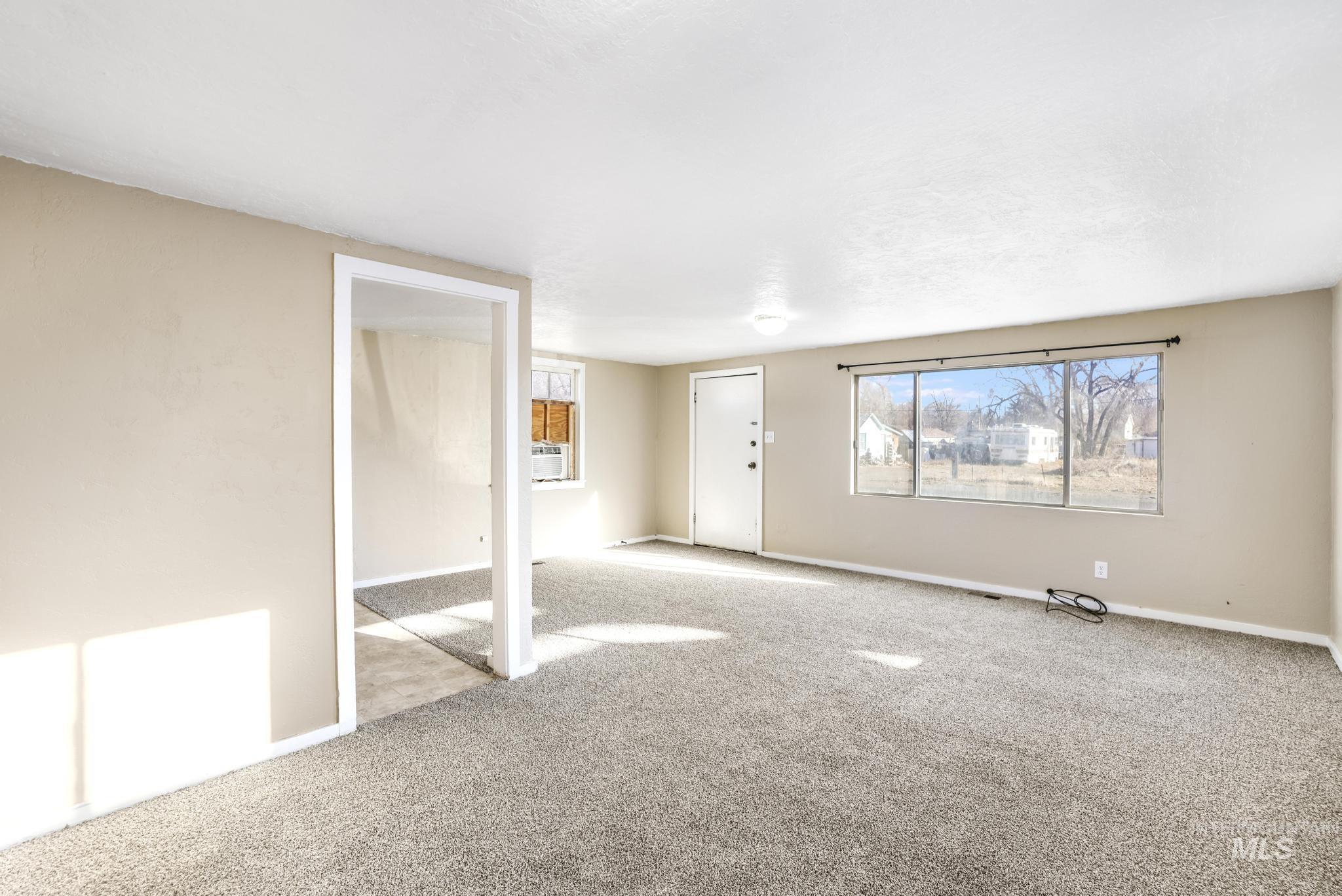 Empty room with carpet floors and baseboards