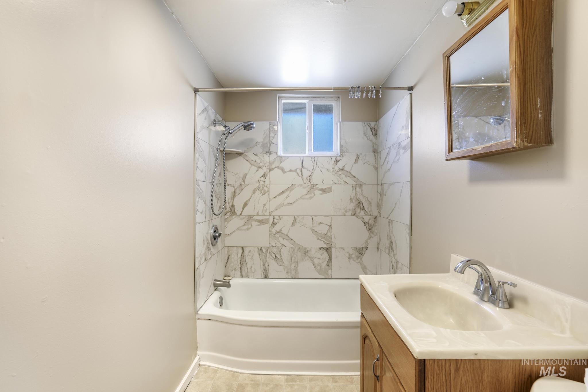 Full bathroom with shower / bathtub combination and vanity