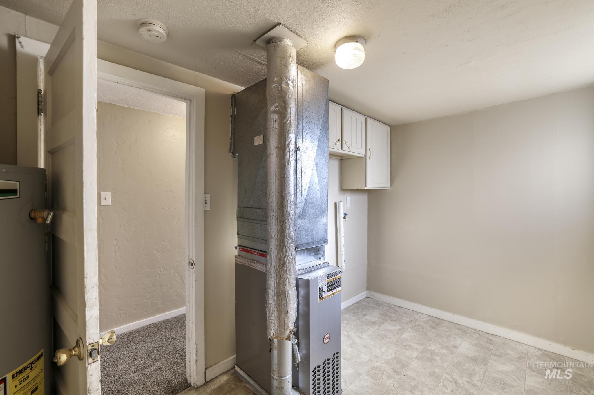 Utilities featuring water heater and heating unit