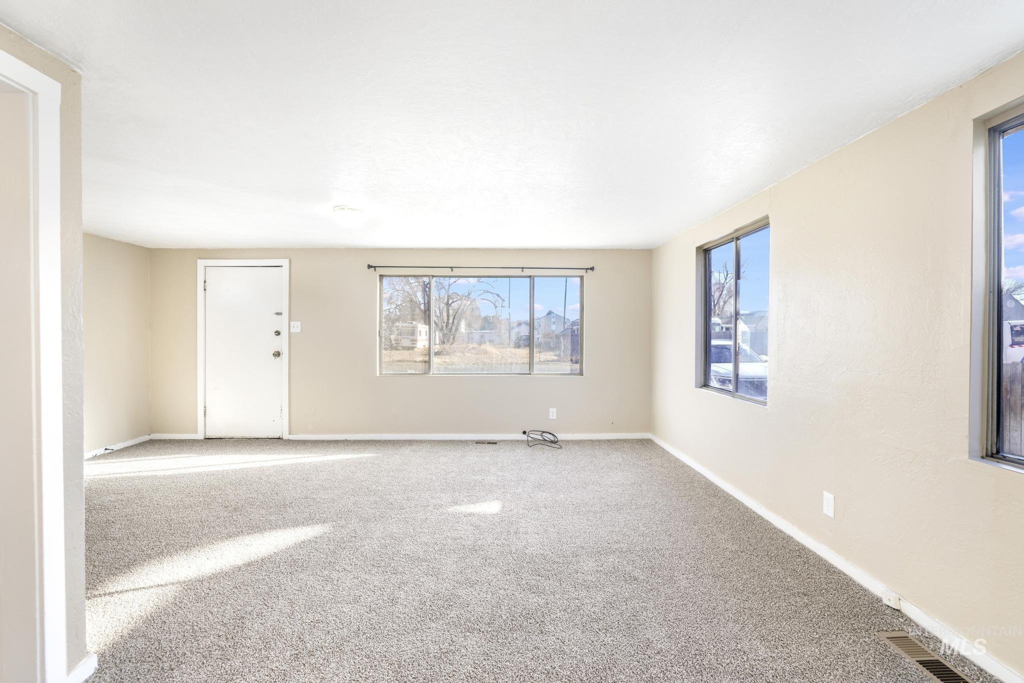 Carpeted empty room with healthy amount of natural light