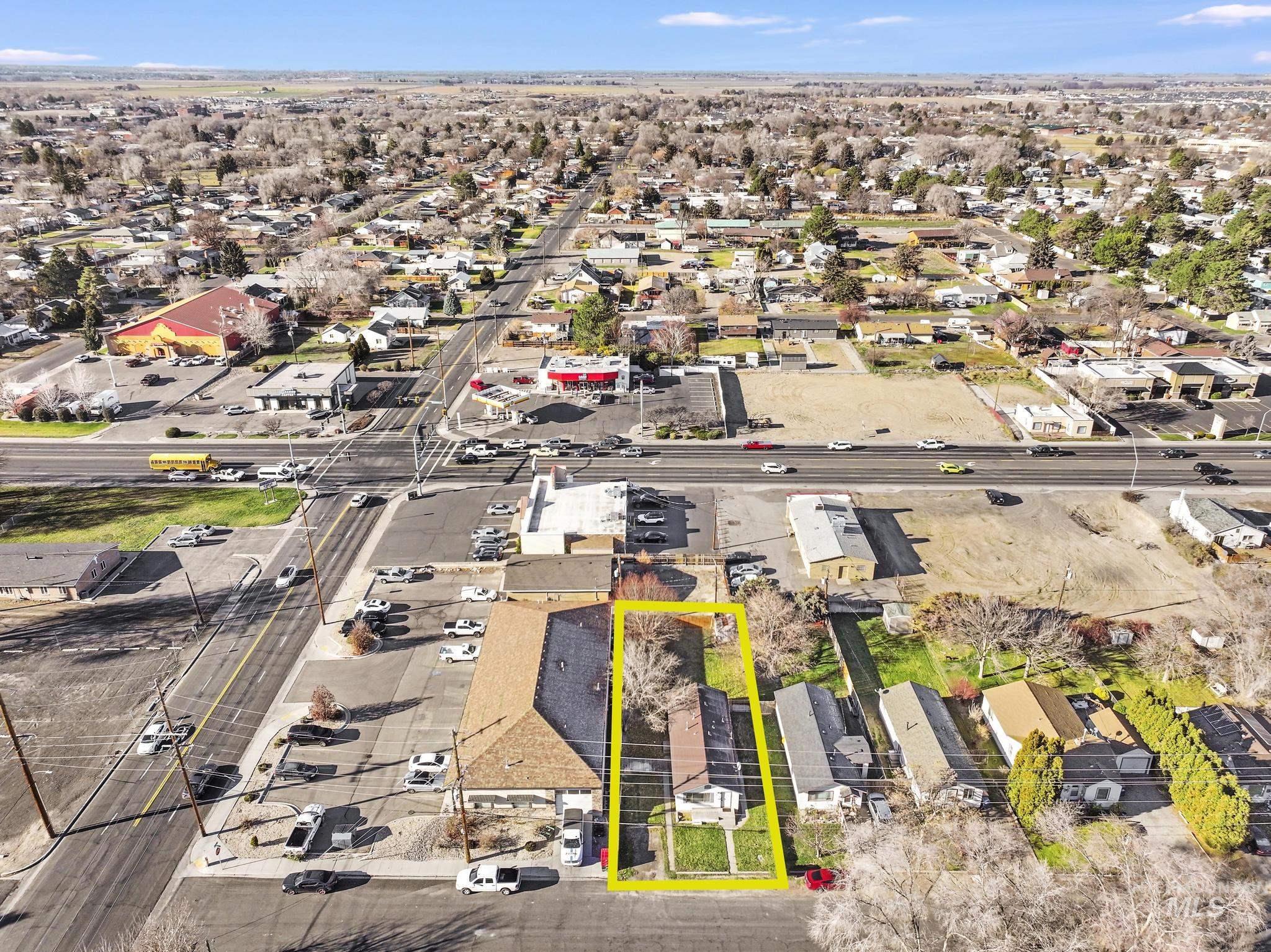 Aerial view of residential area featuring property boundaries highlighted