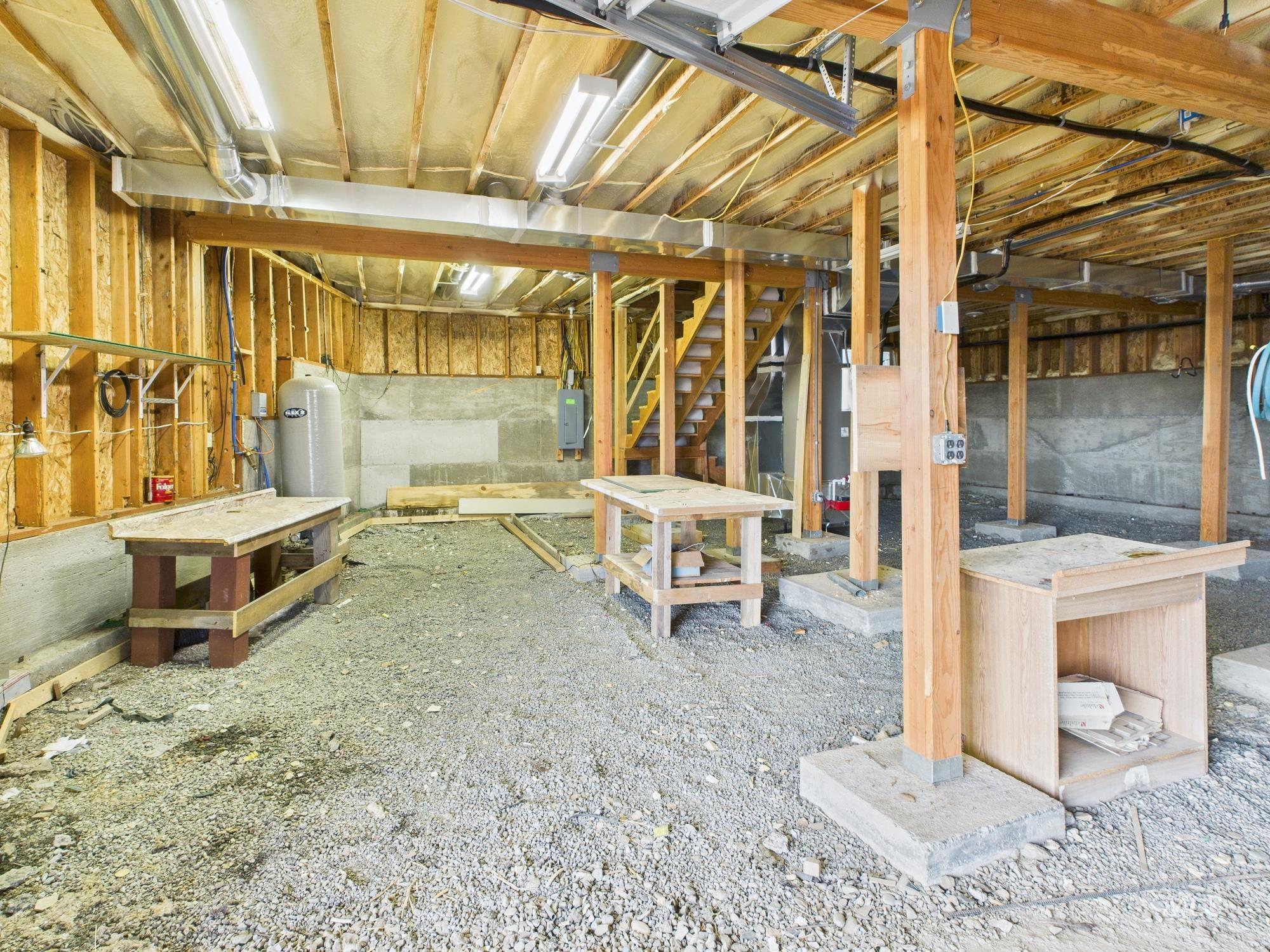 Miscellaneous room featuring stairway and electric panel