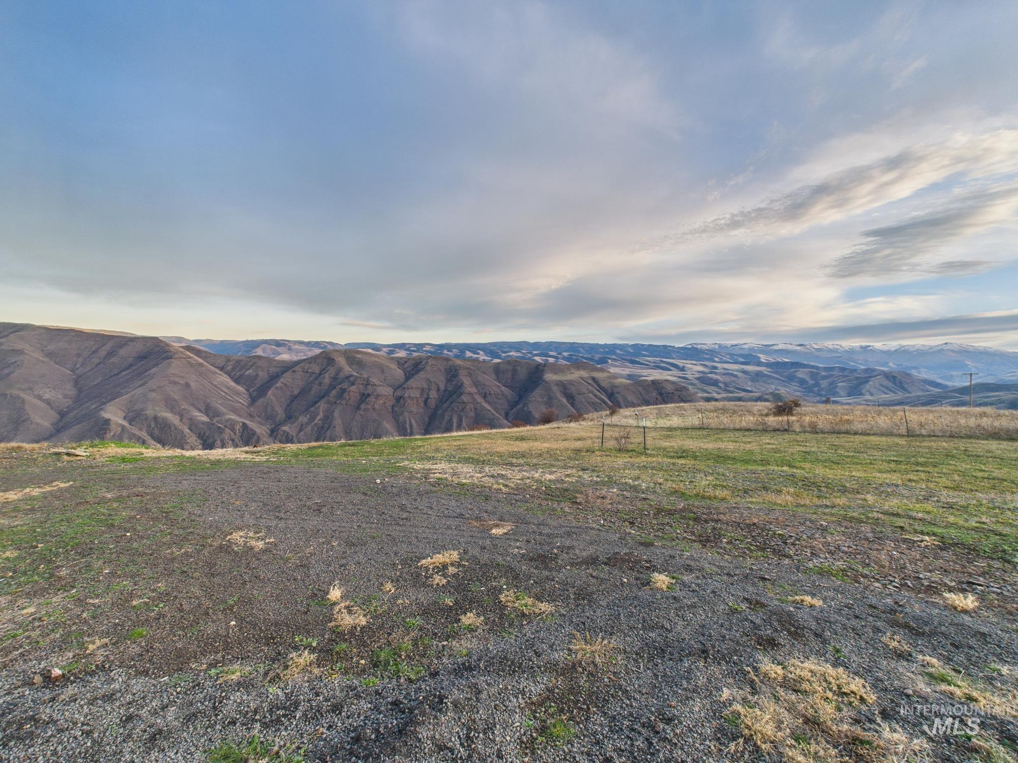 View of mountain backdrop with rural landscape