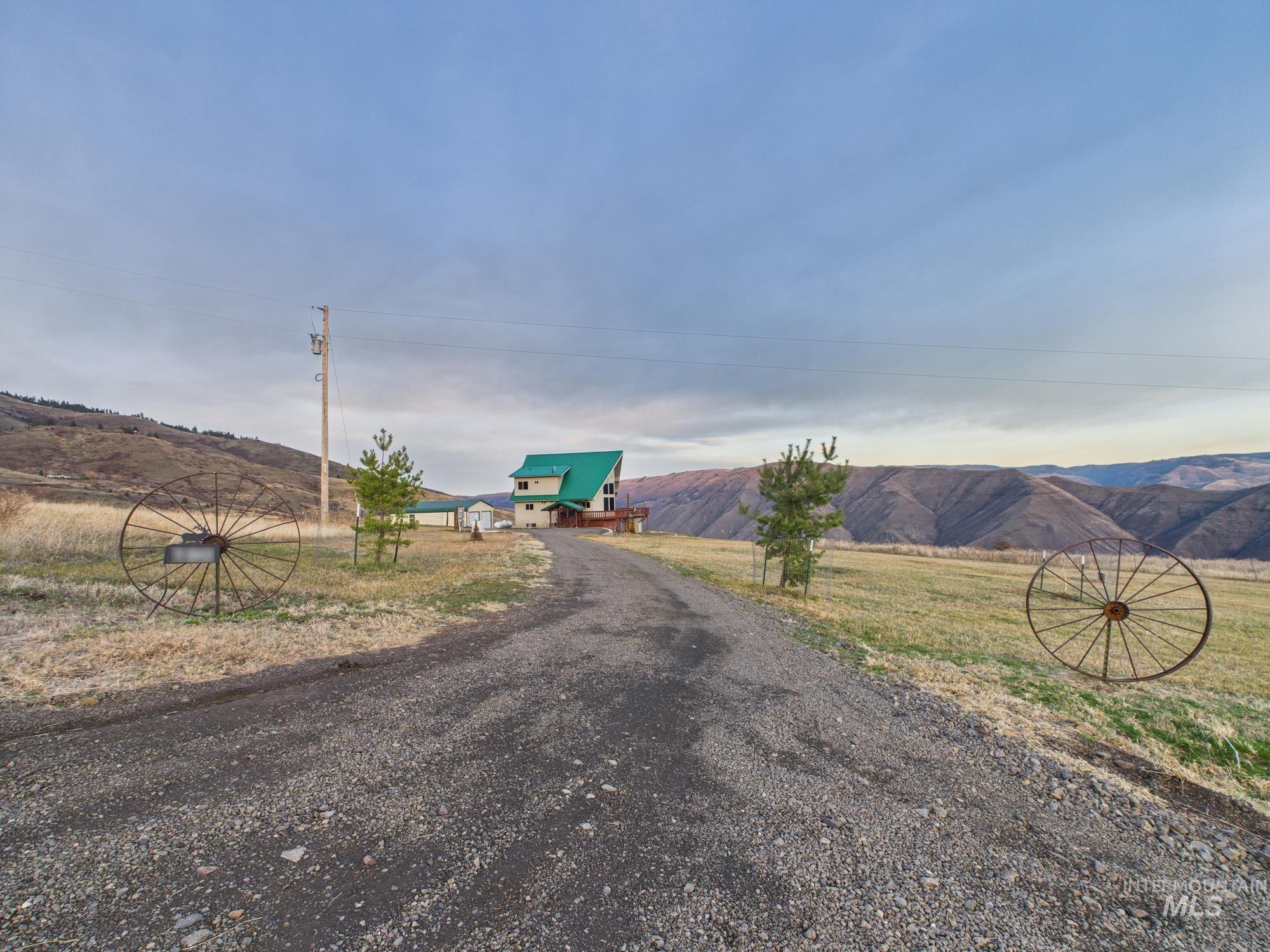 View of dirt / gravel road with a mountain view and a view of rural / pastoral area