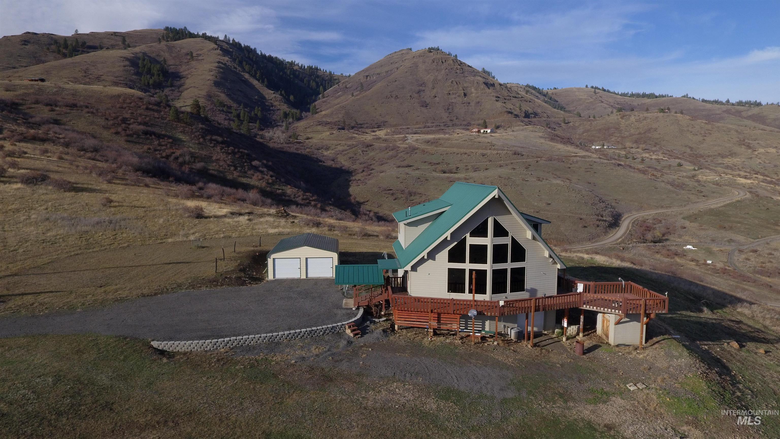 Back of property featuring an outbuilding and a wooden deck