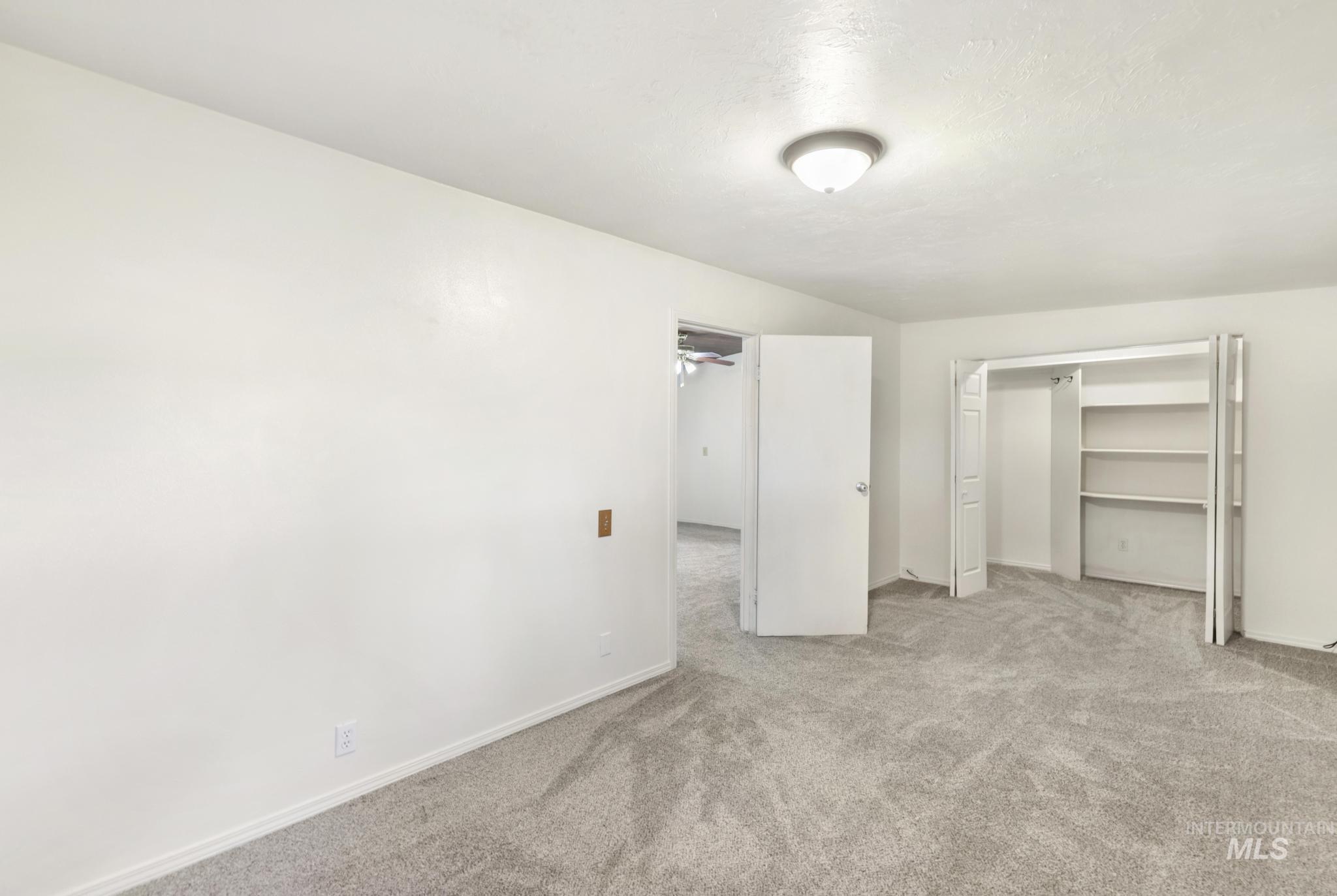 Unfurnished bedroom featuring carpet flooring and a closet