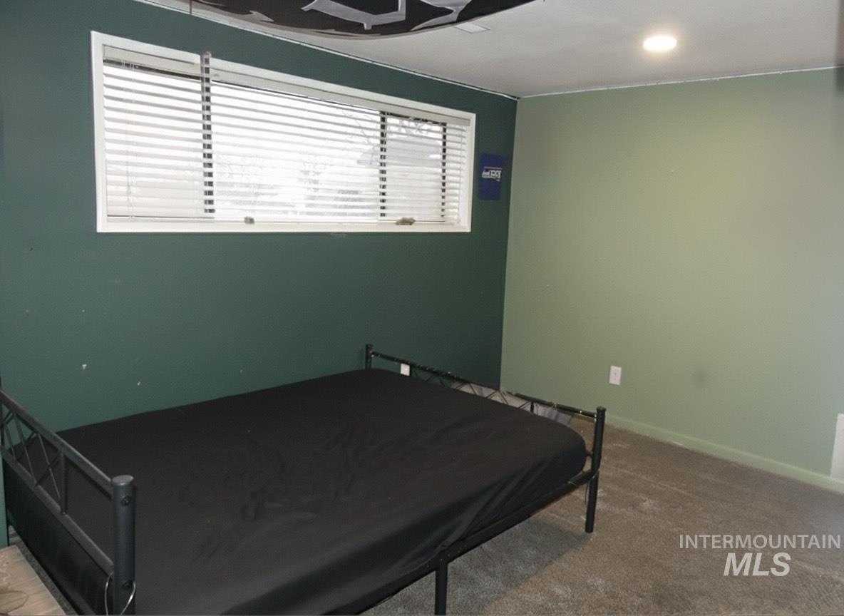 Carpeted bedroom with a ceiling fan