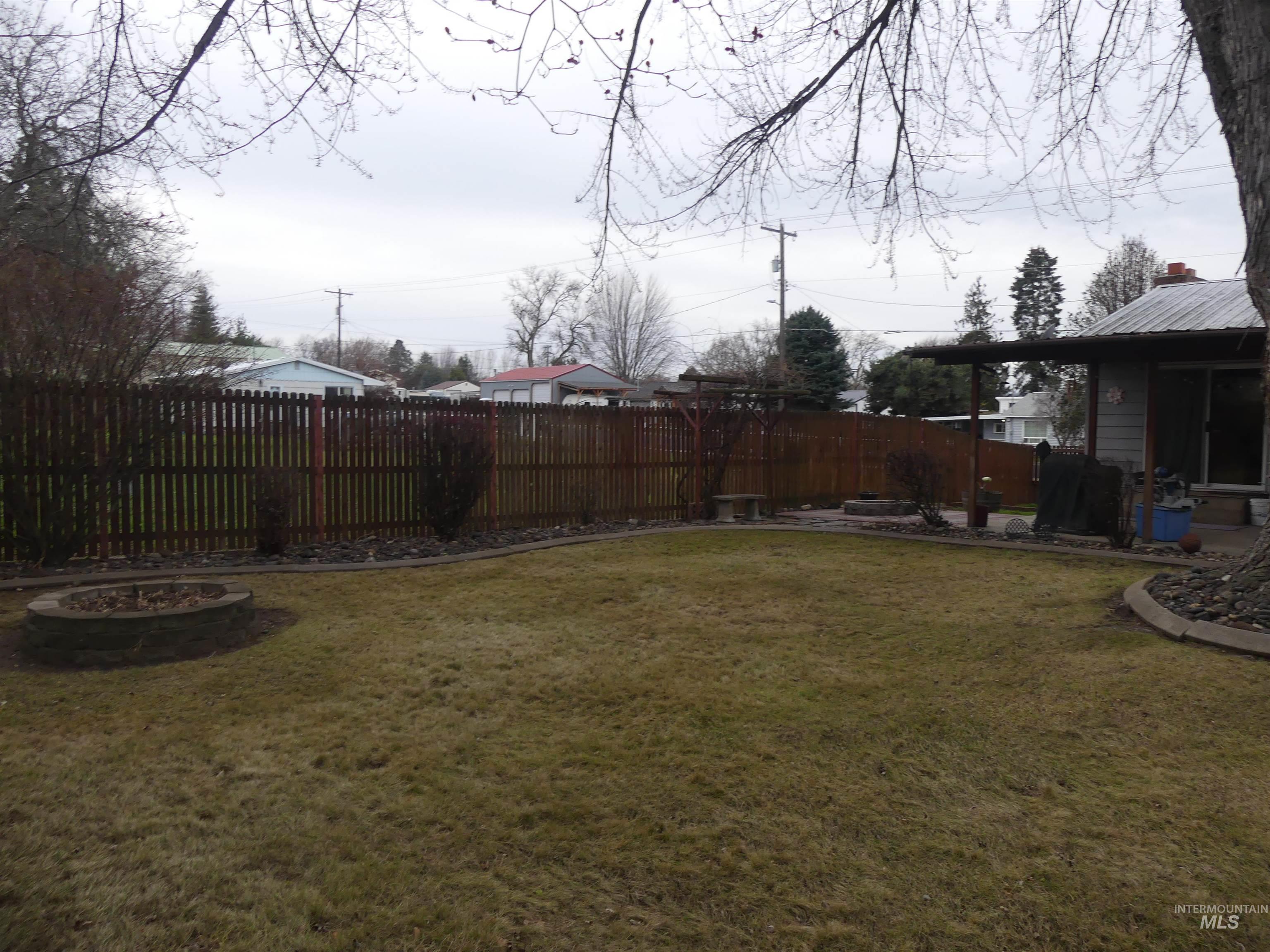 View of yard featuring a fire pit and a patio