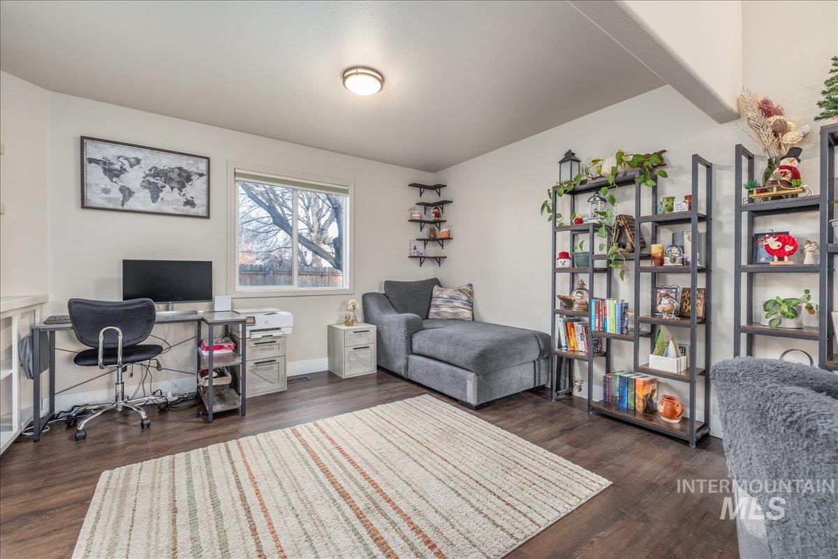 Office area featuring dark wood-style floors