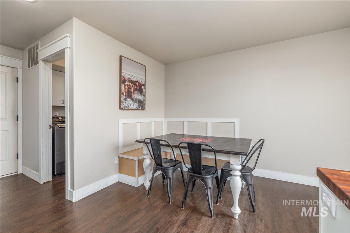 Dining area featuring dark wood-style floors and washer / clothes dryer