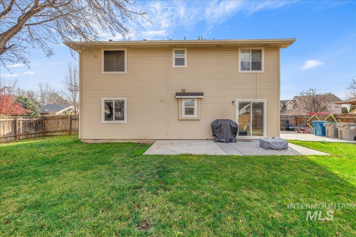 Back of property with a patio and a fenced backyard