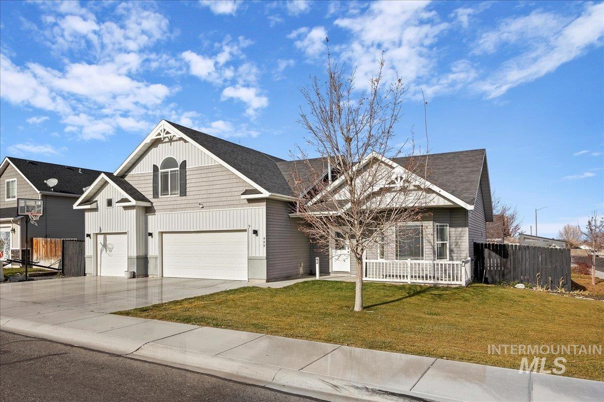 View of front of home with driveway, a garage, and board and batten siding