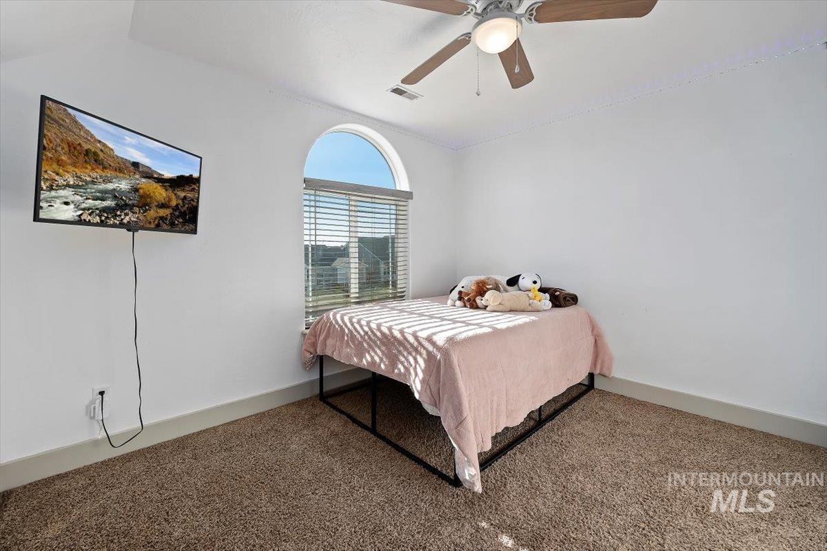 Bedroom featuring carpet floors and ceiling fan