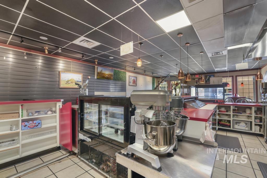 Interior space with light tile patterned floors and a drop ceiling