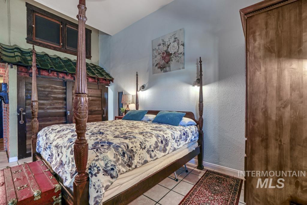 Bedroom featuring tile patterned floors and a textured wall