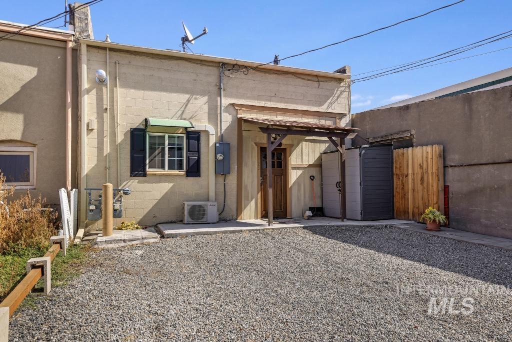Rear view of property with concrete block siding