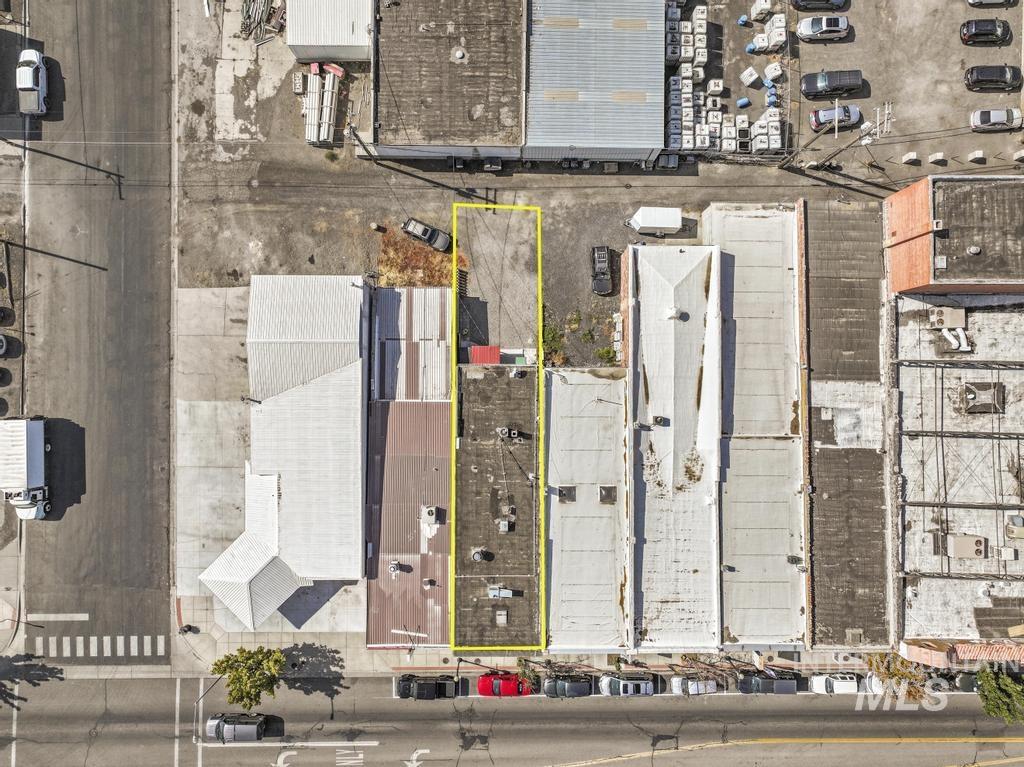Aerial view of property and surrounding area featuring property boundaries highlighted