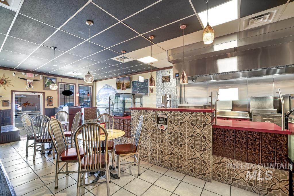 Dining space with a paneled ceiling and tile patterned flooring