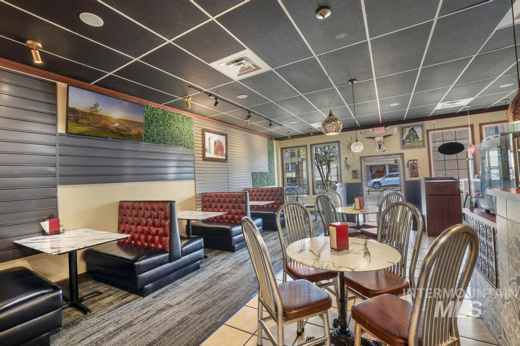 Dining area with a paneled ceiling and tile patterned floors