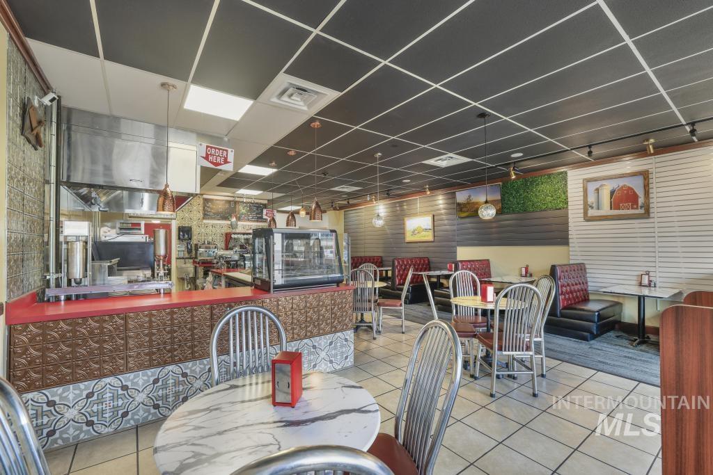 Dining area featuring a paneled ceiling and tile patterned floors