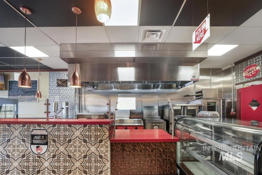 Kitchen with a drop ceiling and hanging light fixtures