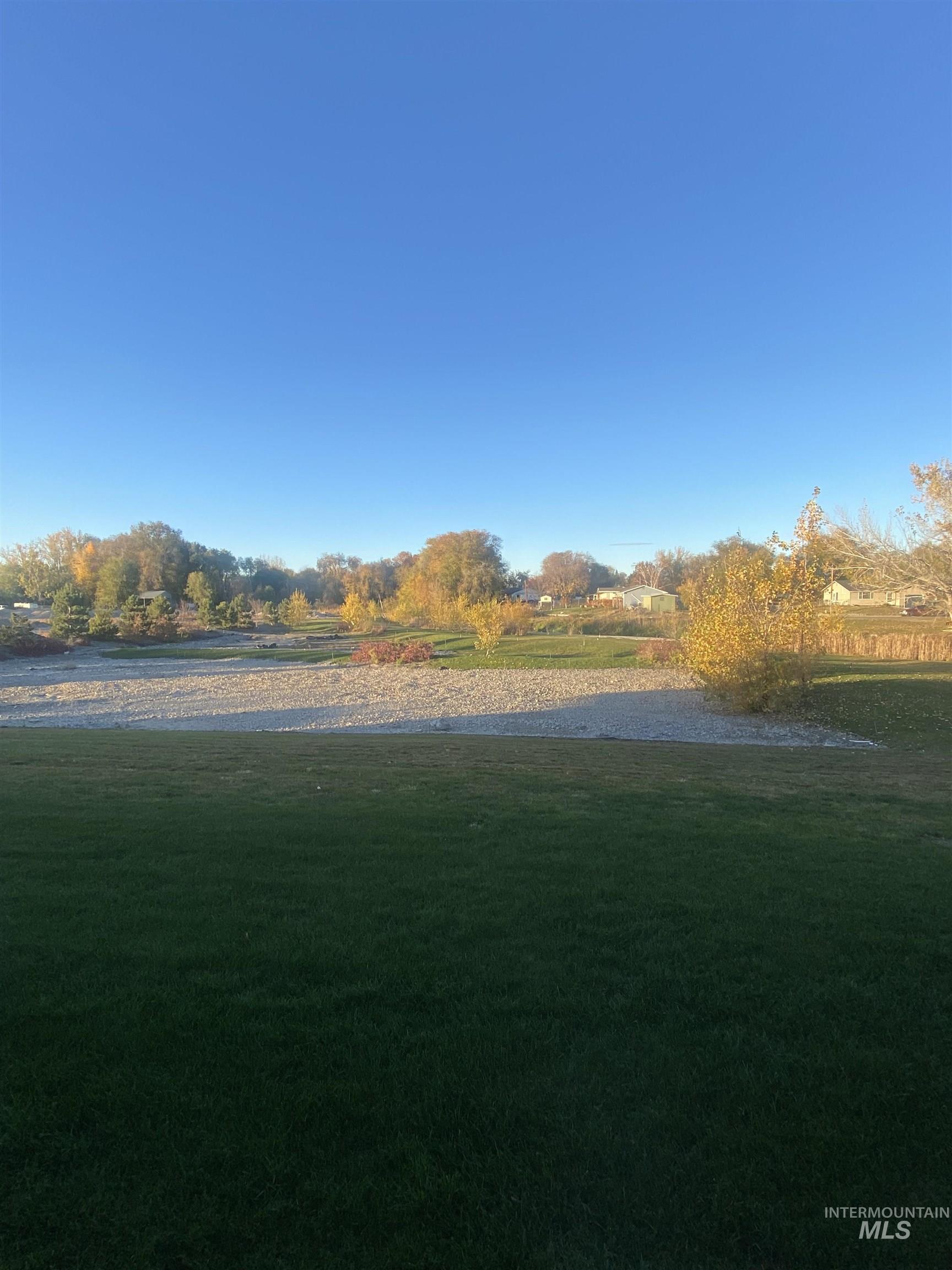 View of green lawn featuring a water view