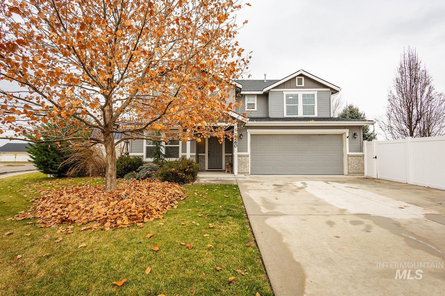 View of front of property with concrete driveway, a garage, and board and batten siding