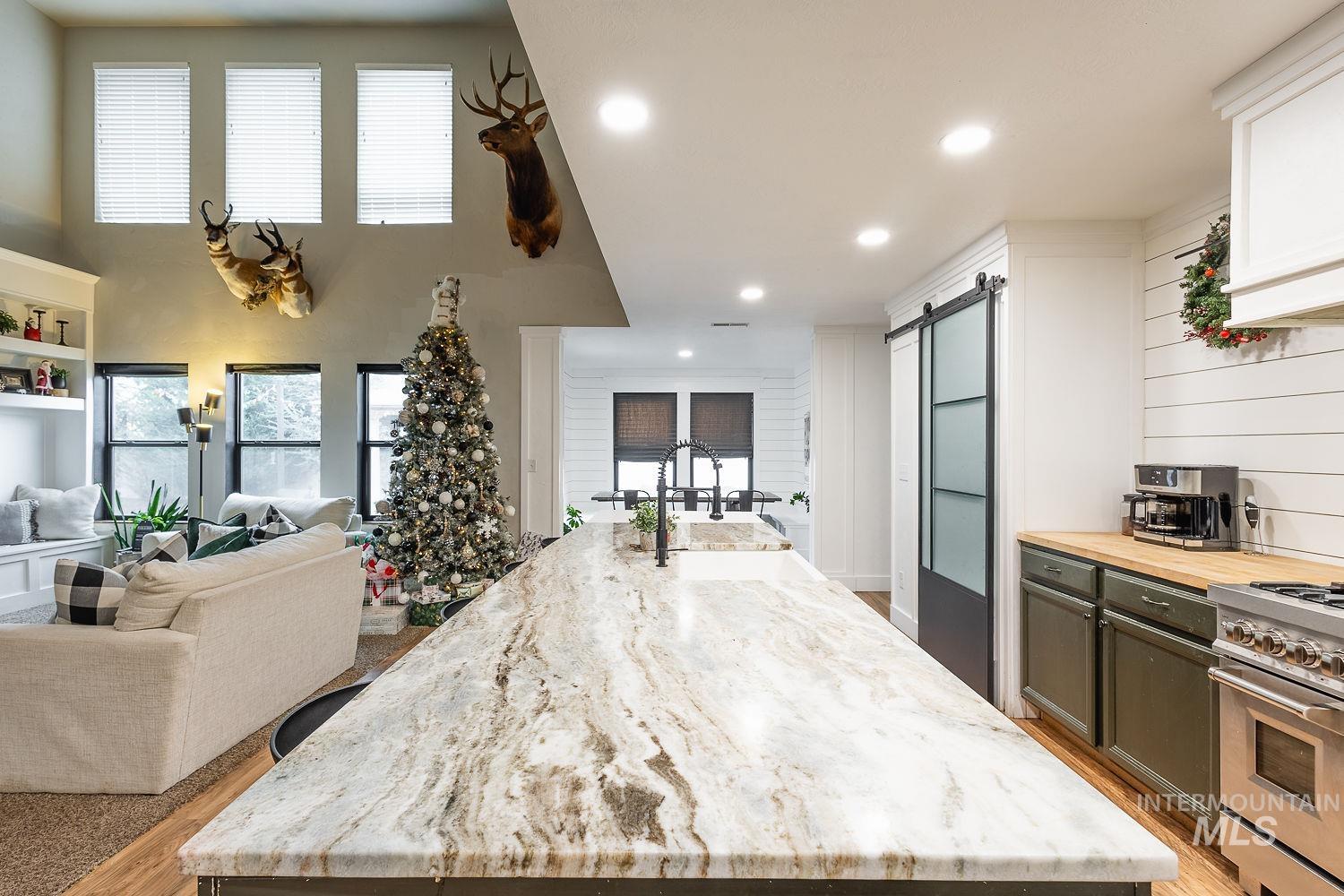 Kitchen featuring high end range, wooden counters, healthy amount of natural light, a barn door, and recessed lighting