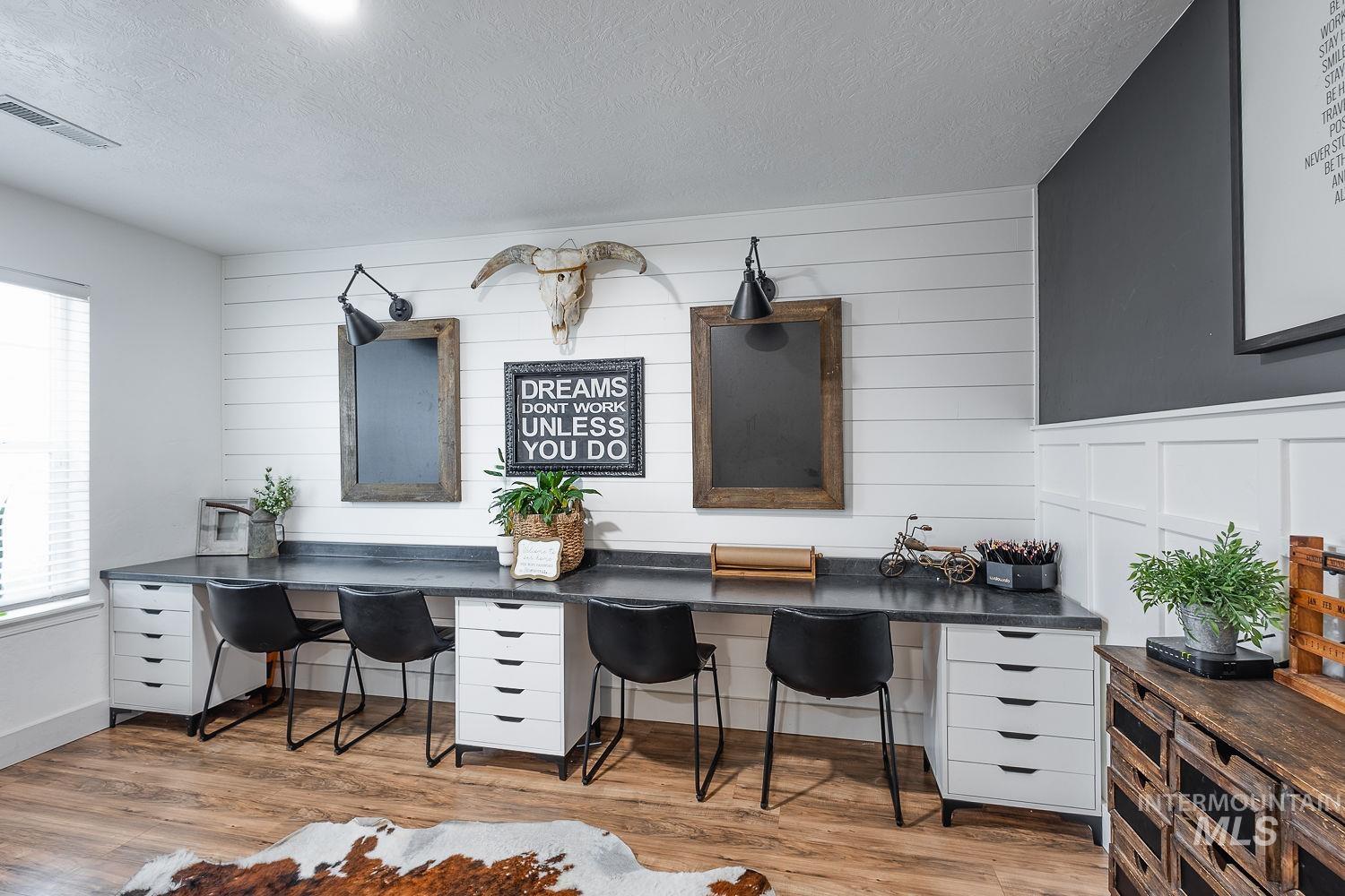 Home office featuring a textured ceiling and light wood finished floors
