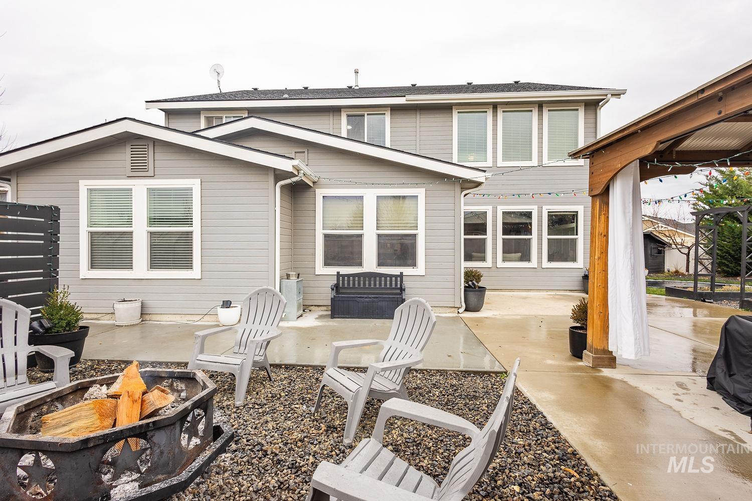 Back of property with a patio area and a fire pit