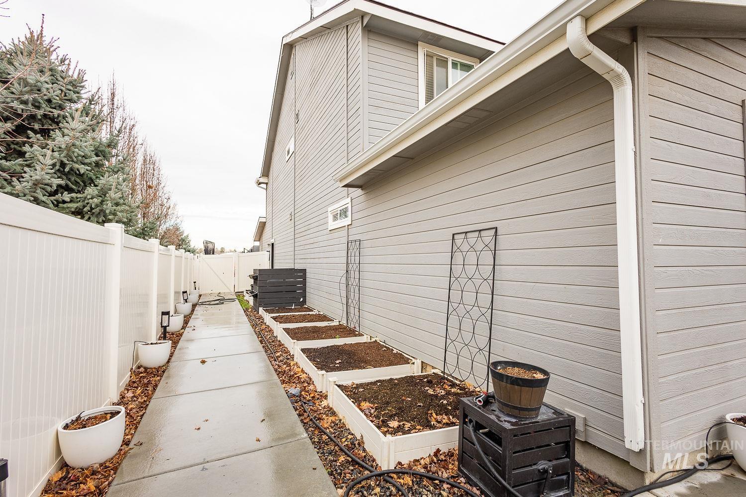 View of property exterior with a vegetable garden and a fenced backyard