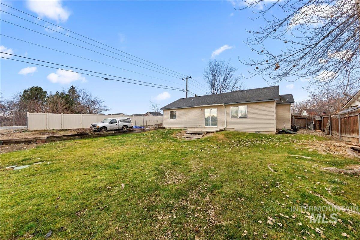 Back of property with a fenced backyard and a patio