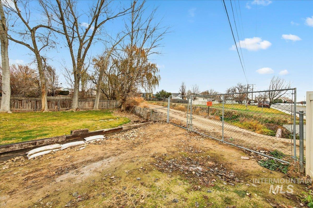 Fenced backyard featuring a gate