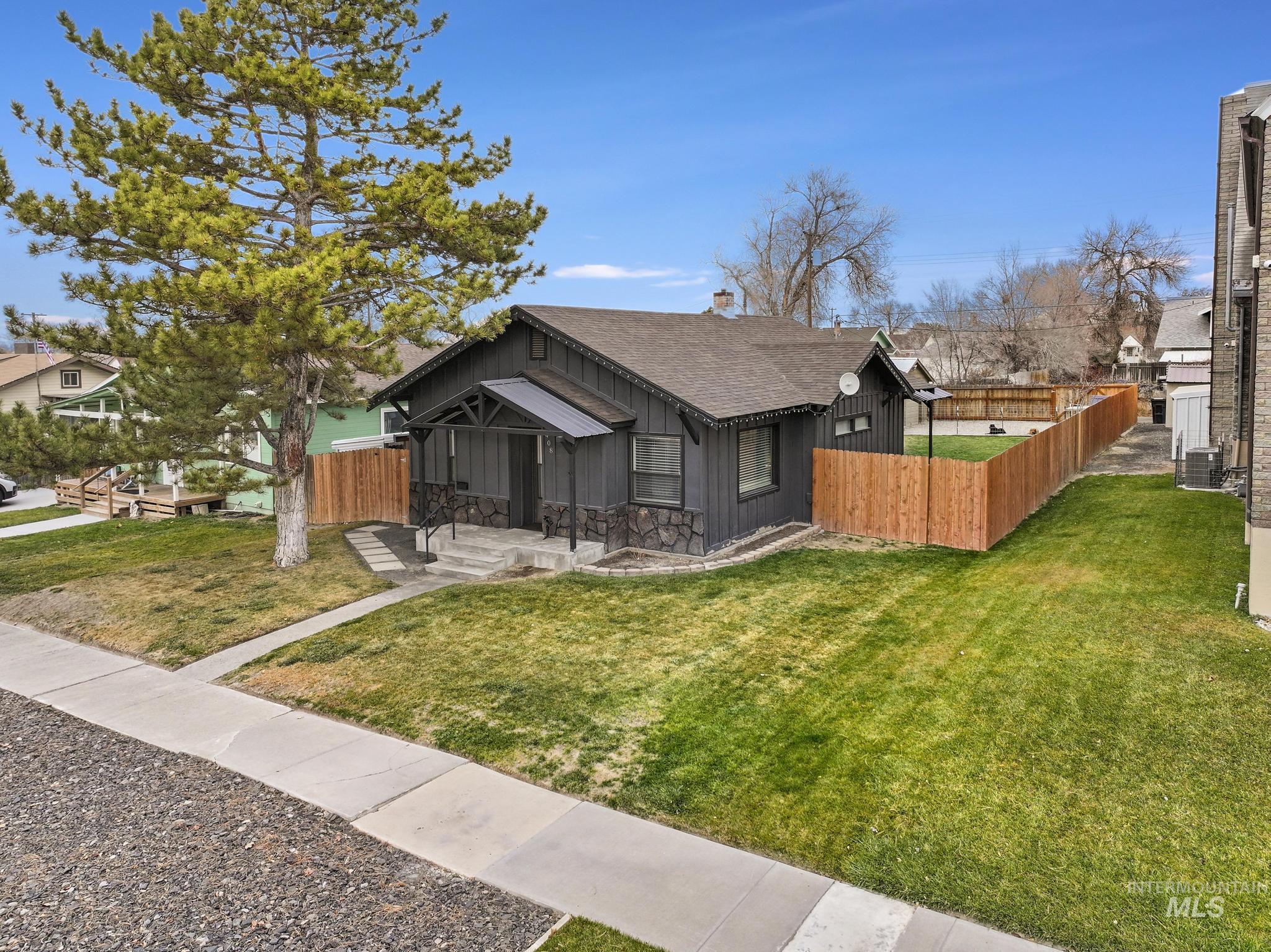 View of front of house featuring board and batten siding and roof with shingles