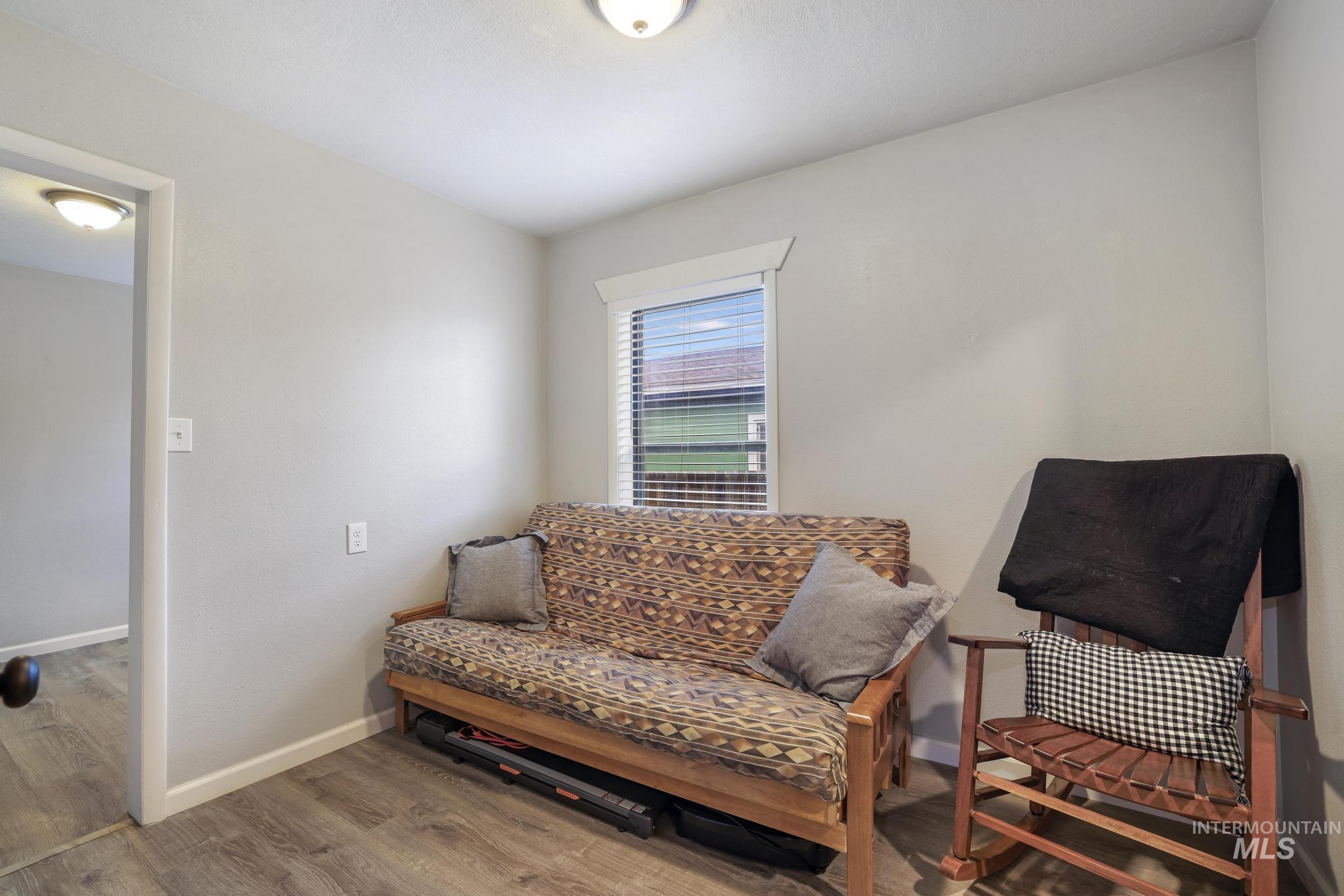 Sitting room with wood finished floors and baseboards