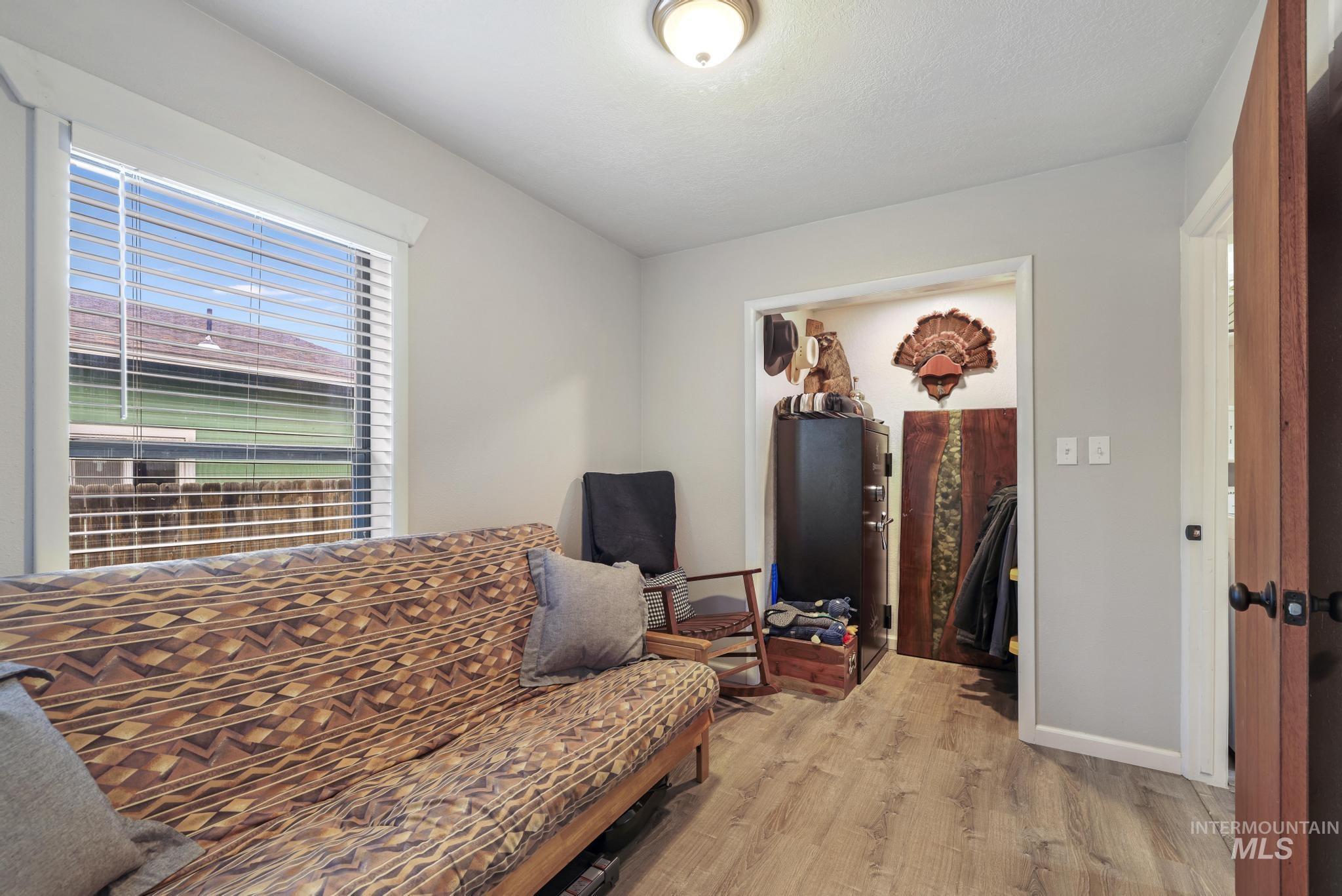 Living area with light wood finished floors and baseboards