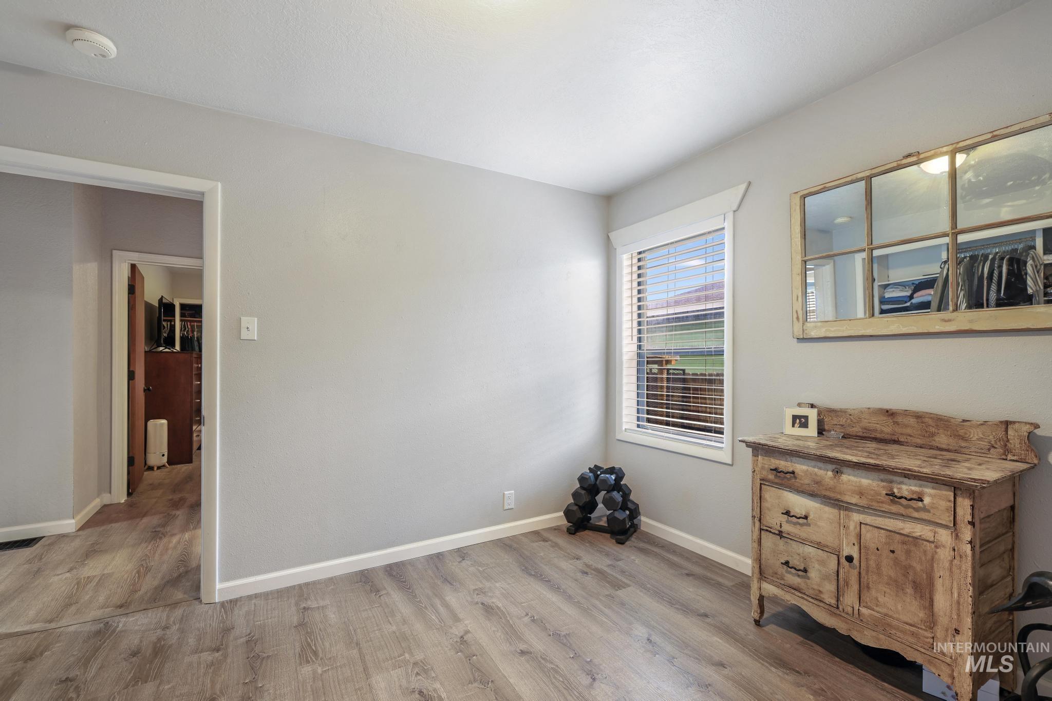 Spare room with light wood-type flooring and baseboards